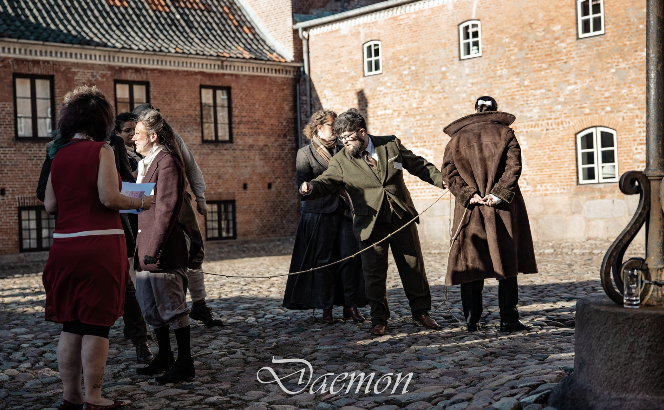 People and daemons making distance measurements and an experiment with rope outside.