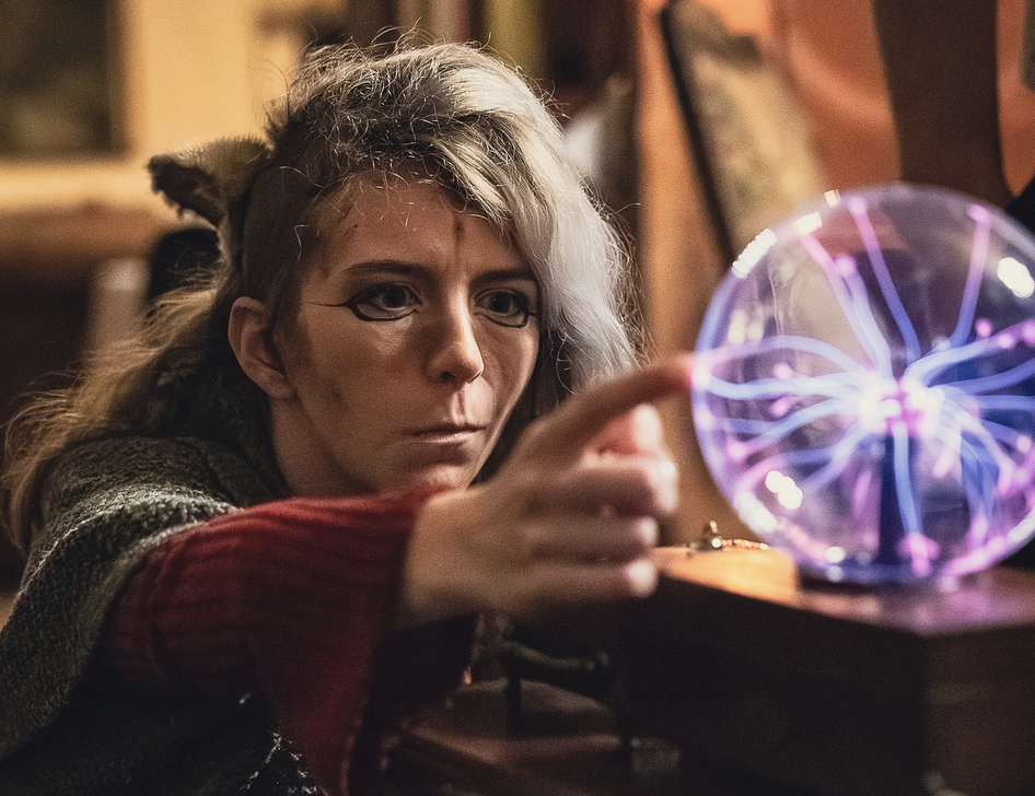 daemon touching a scinece equipment that has lights inside it.